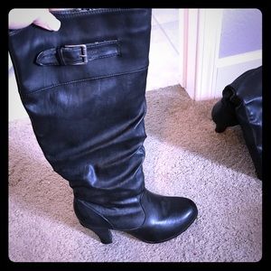 Zip up black boots with size buckle. Size 9